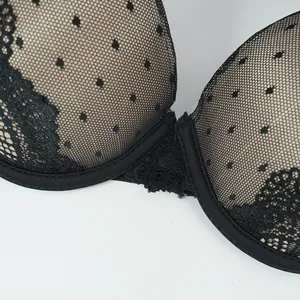 Detailed close-up of polka-dot mesh and delicate lace trim on wired push-up bra