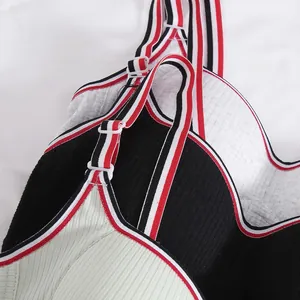 Close-up of ribbed sports bras with striped elastic straps and adjustable buckles