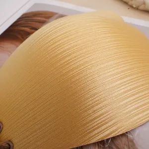 Macro detail of champagne gold invisible bra featuring fine silk pleats and lacing holes