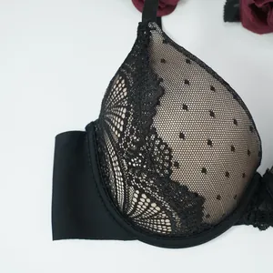 Close-up of black lace floral embroidery and polka dot mesh detailing on push-up bra cups
