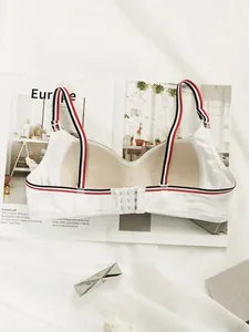 Detail of white wireless sports bra showing breathable mesh lining and 3-row hook closure