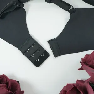 Detail of black lace bra back closure with three-row hook-and-eye design and smooth seams