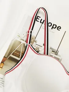 Close-up of white ribbed bra with sporty red, black, and white striped shoulder straps
