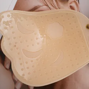 Detail view of skin-tone silicone face mask with raised massage dots and ear loops