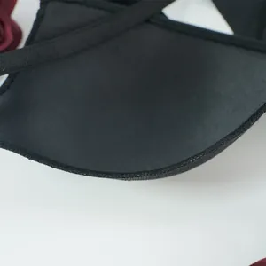 Macro detail of breathable mesh lining and padded cups on a black lace push-up bra
