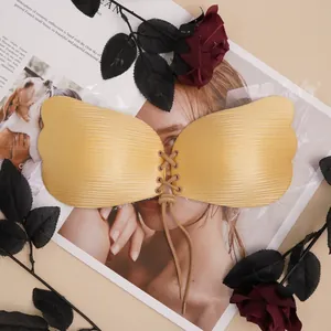 Detail of gold wing-shaped invisible push-up bra with drawstring and ribbed texture