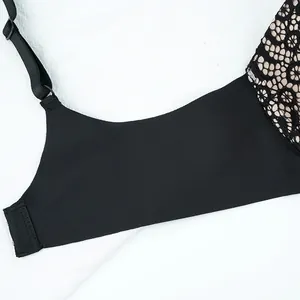Detail of black lace bra with floral embroidery and wide side wings for shaping support