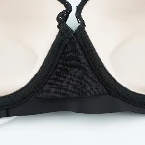 Detail of breathable mesh fabric and elastic seams on the black push-up bra inner cup