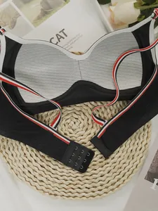 Detail of black wireless sports bra with striped straps and breathable mesh lining