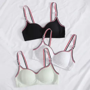 Ribbed seamless sports bras in black, grey, and mint with striped straps on white fabric