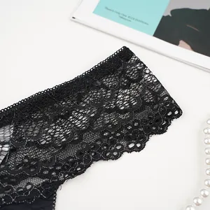 Detailed macro view of black floral lace with shimmering silver threads and delicate edges