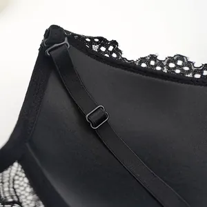 Macro detail of adjustable straps and lace trim on black underwire lingerie set
