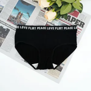 Detail of black ribbed cotton panties with LOVE FLIRT PEACE elastic waistband and lace decor