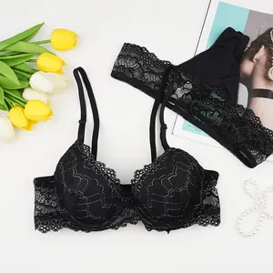 Elegant black lace lingerie set with underwire bra and matching thong on a stylist background
