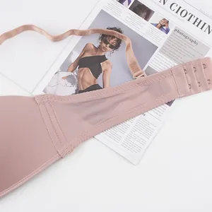 Detail of breathable mesh side wings and adjustable three-row hook closure on pink bra