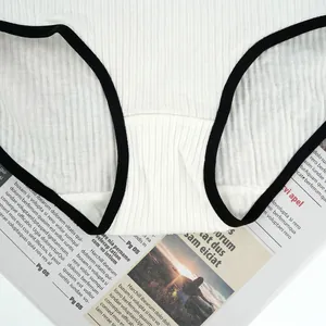 Detail of white ribbed cotton panties showing black contrast trim and quality stitching