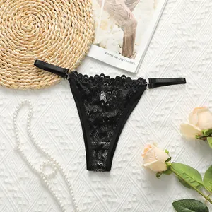 Detail of black lace panties with intricate floral patterns and metallic ring buckle
