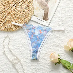 Detail of light blue lace T-back thong with butterfly print on textured fabric