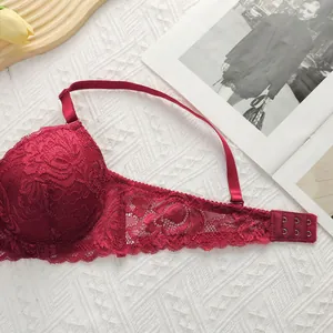 Close-up of burgundy lace bra with floral patterns and a three-hook back closure