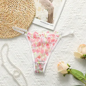 Sultry white sheer lace thong with pink floral embroidery and metal ring accents
