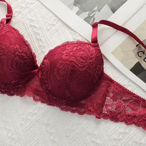 Detailed macro view of burgundy lace bra cups with intricate floral rose patterns