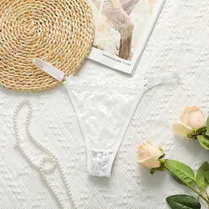 Detail of white lace thong with adjustable metal buckle and floral embroidery textures
