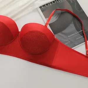 Sexy red lace push-up bra with shimmering fabric detail on a silk background