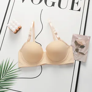 Elegant seamless lace bra set in beige, features adjustable straps on a minimalist background