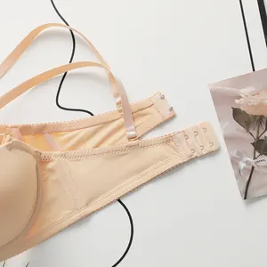 Detail of beige seamless bra featuring back straps and three-row hook-and-eye closure