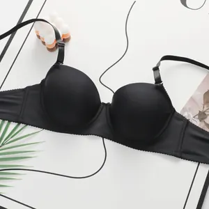 Detailed view of seamless black lace bra with smooth cups and adjustable straps