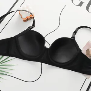 Detail of black seamless bra cup with wavy edge trim and adjustable thin shoulder straps
