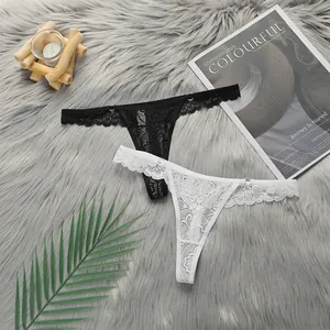 Detailed view of floral lace thong set with metal rings on soft faux fur background