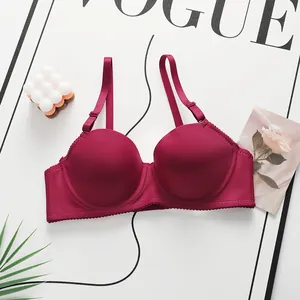 Lace-trimmed wine red seamless bra with adjustable straps for women, styled on flat lay