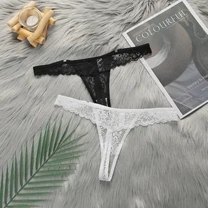 Detail of two-piece lace thongs in black and white with floral embroidery on plush background