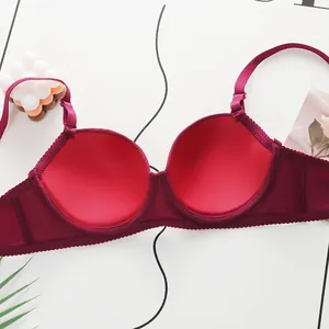 Detailed interior of a burgundy lace bra showing smooth cups and breathable mesh wings