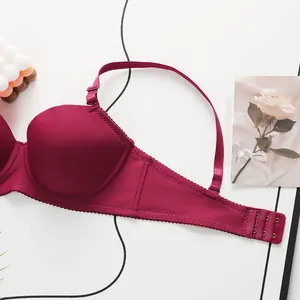 Detail view of burgundy lace bra showing seamless three-row back hook closure and wavy hem