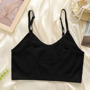 Close-up of black seamless U-back camisole top on elegant silk background with pearls