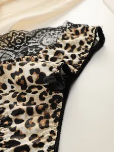 Detail of leopard print fabric with black lace trim and a satin bow on women's panties