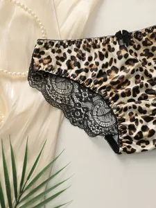 Detail of leopard print panties with floral black lace trim and silk bow decoration