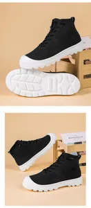 Detail of black breathable knit high-top sneakers with white thick anti-slip rubber soles