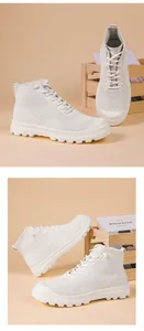 Detailed view of white high-top knit sneakers with breathable mesh and thick rubber sole