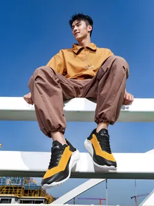 Mens thick sole sneakers in yellow and black paired with casual street style apparel