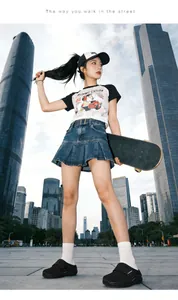 Street style shot of chunky black mule sandals paired with a denim skirt and skateboard