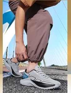 Detail of grey and black breathable climbing shoes with thick wavy soles on bridge