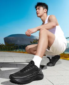 Outdoor shot of men's black thick-soled running shoes with breathable mesh and Trend logo