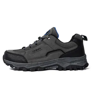 Scarpe da trekking in camoscio grigio scuro con suola in gomma e dettagli blu