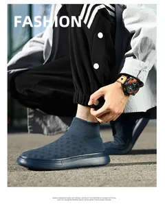 Close-up of navy knit sock sneaker with breathable fly-knit texture and thick sole