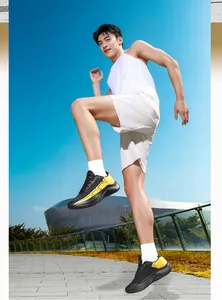 Dynamic shot of men's black and yellow running shoes with thick cushioning on the outsole