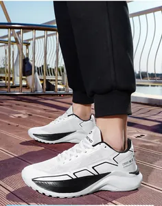 Close-up of men's white breathable mesh running shoes with thick cushioned soles on wood