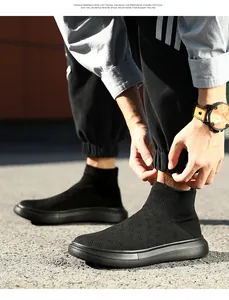 Detailed view of black mid-top knit sock sneakers with thick rubber soles for daily wear